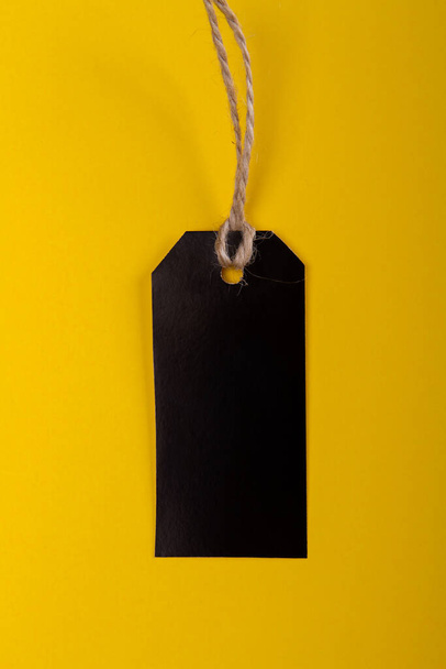 black price label tag on yellow background. black friday consept - Fotografie, Obrázek
