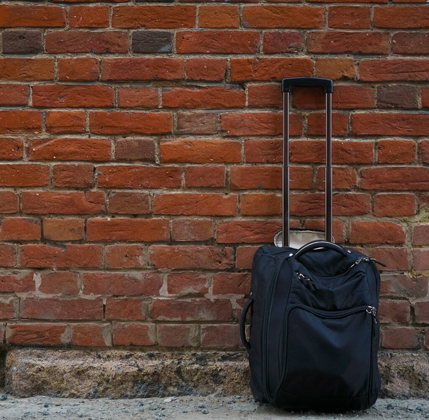 Packed suitcases on red  brick wall background. empty copy space for inscription. - Foto, Imagem