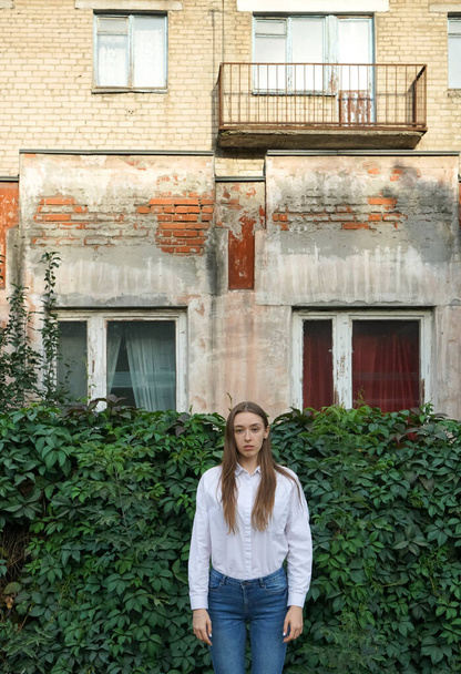 Young  Woman in a white shirt near House with Two Windows in Ivy.  Autumn or Summer season.  - Fotoğraf, Görsel