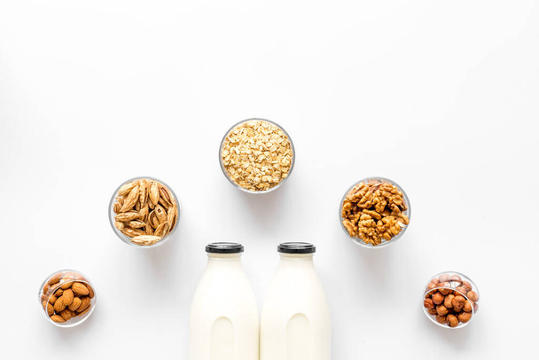 Vegan non-diary milk. Alternative types of milk with nuts and oat - Fotografie, Obrázek