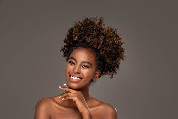 Beauty portrait of woman with afro posing in studio. - Фото, изображение