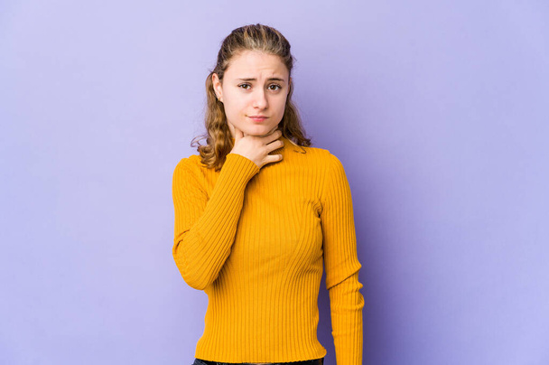 Young caucasian woman on purple background suffers pain in throat due a virus or infection. - Photo, image