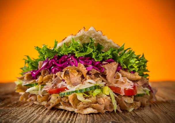 Turkish Doner Kebab Sandwich on wooden background. - Photo, image