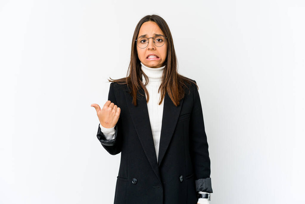 Young mixed race business woman isolated on white background shocked pointing with index fingers to a copy space. - Photo, Image