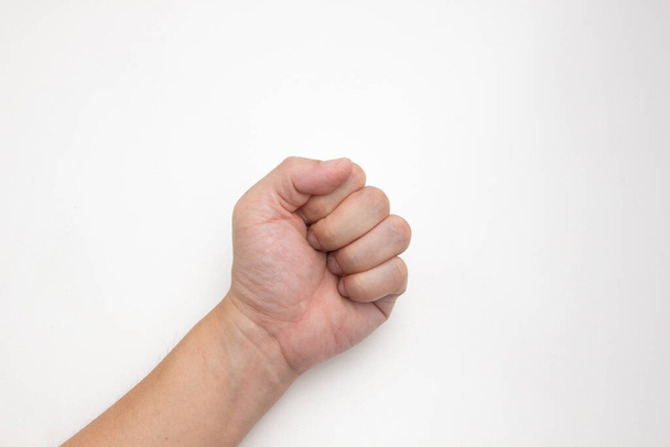 The left hand of a white Asian man fisting on a white background. - Photo, Image