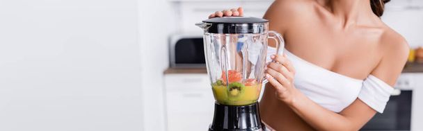 Website header of woman making smoothie from ripe fruits  - 写真・画像