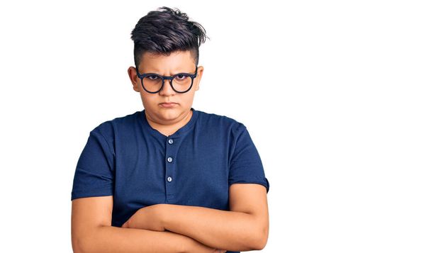 Little boy kid wearing casual clothes and glasses skeptic and nervous, disapproving expression on face with crossed arms. negative person.  - Photo, Image