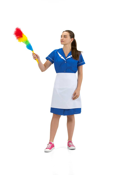 Portrait of female made, cleaning worker in white and blue uniform isolated over white background - Foto, afbeelding