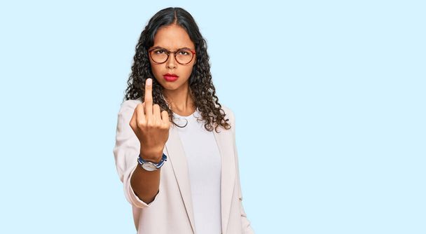 Young african american girl wearing business clothes showing middle finger, impolite and rude fuck off expression  - Foto, Imagen