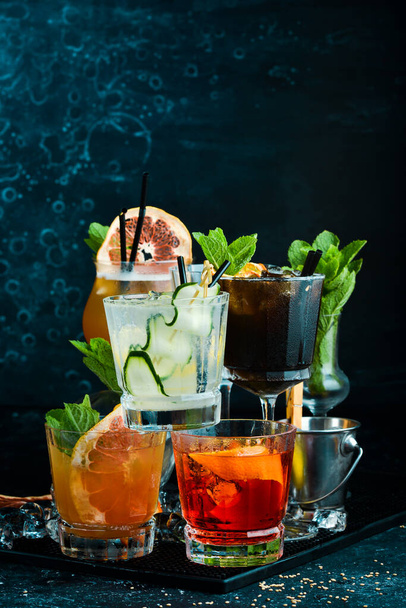 Set of colored alcoholic cocktails on a black stone background. Menu bar. Alcohol. - Fotó, kép