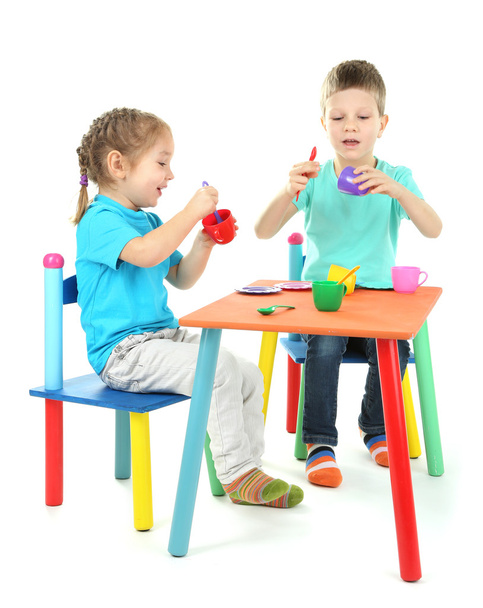 Little children playing with colorful tableware isolated on white - Foto, afbeelding