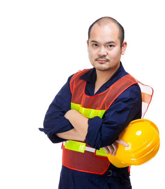 Будівельний майданчик працівник тримає шолом
 - Фото, зображення