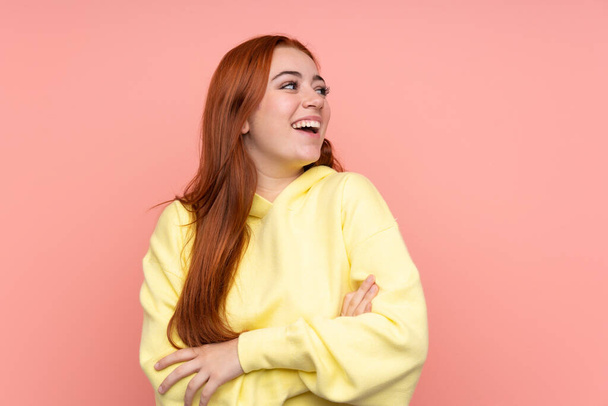 Redhead teenager girl over isolated pink background happy and smiling - Φωτογραφία, εικόνα