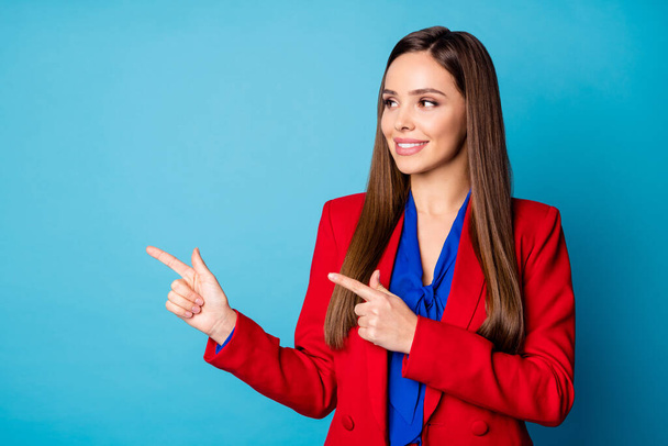 Photo of attractive pretty business lady hold arms directing side fingers empty space sales manager wear red luxury trousers suit blouse shirt isolated blue color background - Φωτογραφία, εικόνα