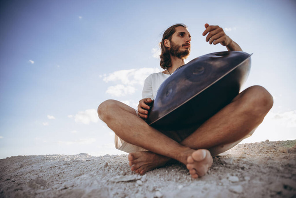handpan in the hands of a musician. Music background for alternative contemporary music for meditation and relaxation. Copy space - Valokuva, kuva