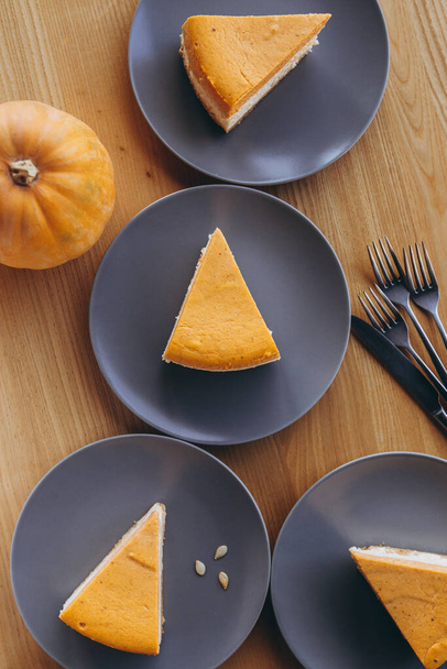 Slices of Freshly Baked Pumpkin Pie on cozy cafe background, selective focus, noise effect - 写真・画像