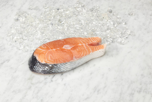 Salmon slice on marble slab. - Photo, image