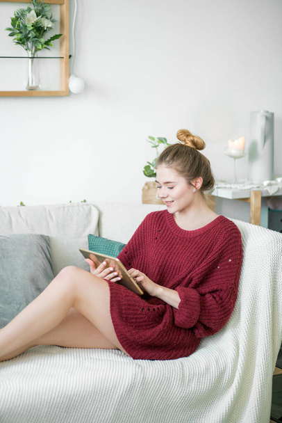 pleasant girl in knitted sweater doing online shopping - 写真・画像