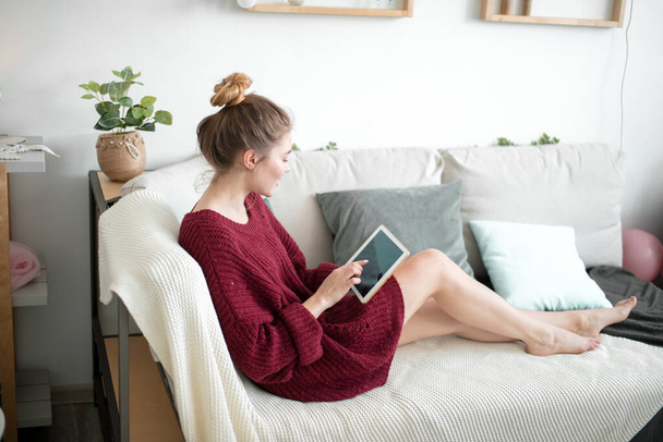 young attractive housewife spending time in fron of the tablet - 写真・画像