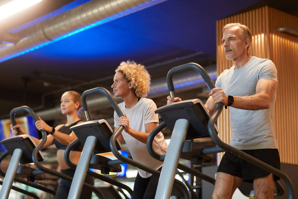 People running on treadmills - Photo, Image