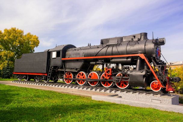old locomotive stands on a pedestal as a monument - Photo, Image