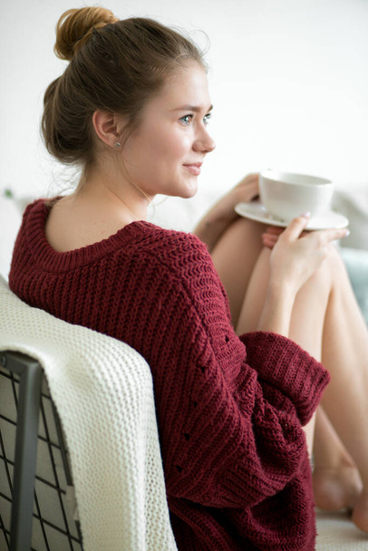 good-looking housewife having breakfast on the couch - Photo, Image