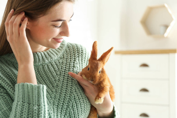 Young woman with adorable rabbit indoors. Lovely pet - Photo, Image