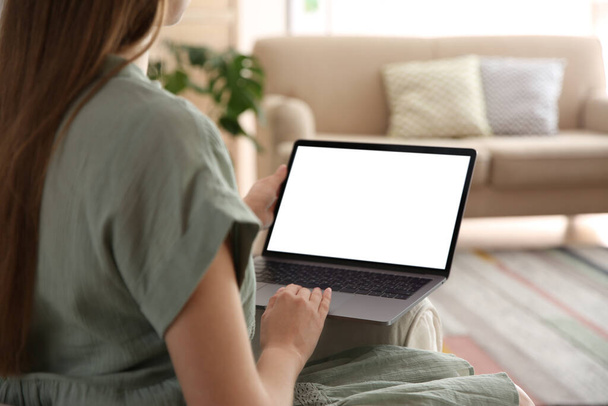 Woman using laptop at home, closeup. Space for design - Zdjęcie, obraz