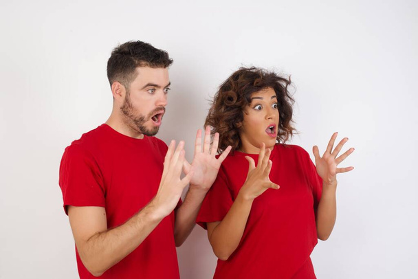 couple in studio, exited and shocked faces  - Photo, Image