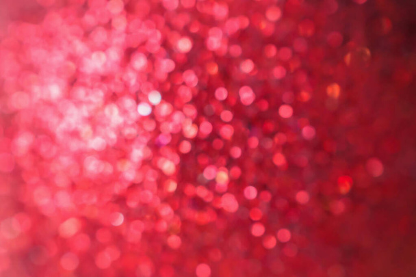 Αφηρημένη θολούρα κόκκινο λάμψη λάμψη defocused bokeh φως χριστουγεννιάτικο φόντο - Φωτογραφία, εικόνα