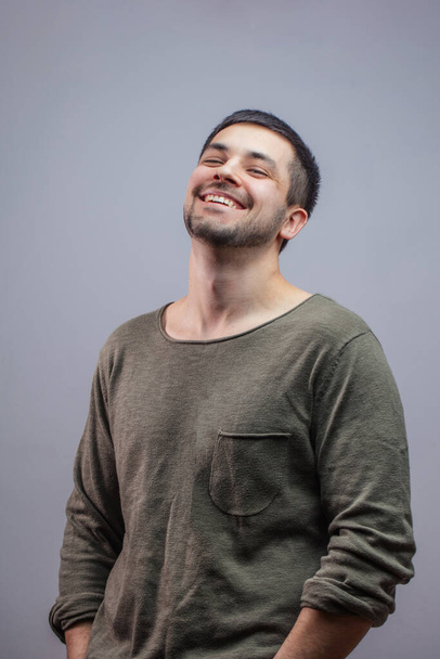 Portrait of sporty young man laughing at joke - Фото, изображение