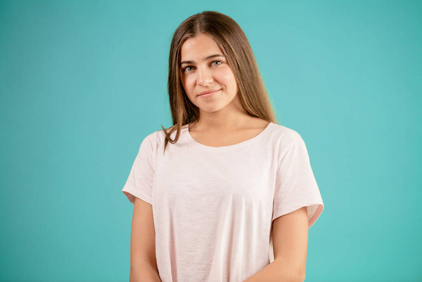 pleasant young brown-haired female standing in white T-shirt - Fotó, kép