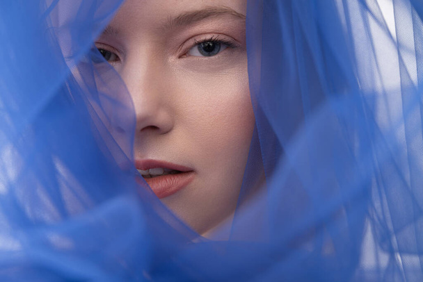 Attractive young woman wearing beautiful blue veil - Photo, image