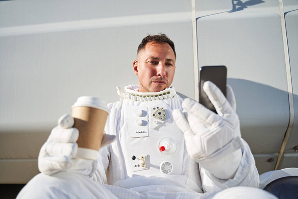 Video call with drinking coffee astronaut - Fotó, kép