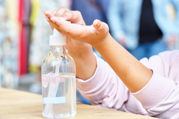 Person squeezes antiseptic gel from a bottle. - 写真・画像