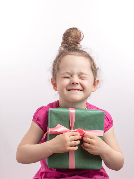 ginger kid with closed eyes is happy to get a gift on her Birthday - Photo, Image