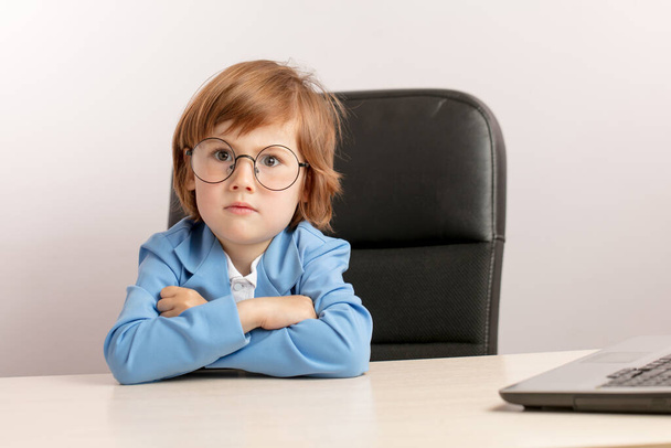 handsome little boy in round glasses is pretending a CEO of the company - Фото, изображение