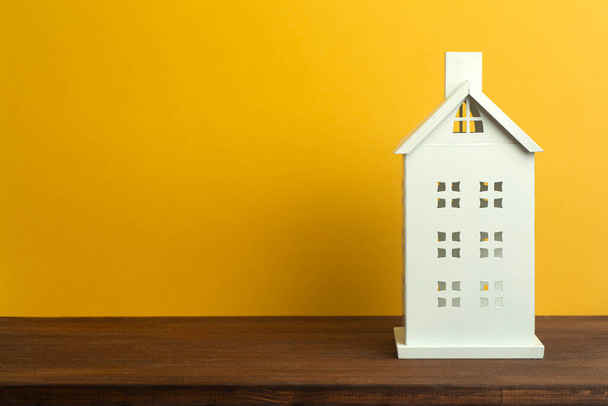 Toy house on yellow background. Real estate, rental housing and house concept. - 写真・画像