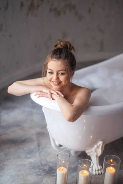 smiling girl is taking a bath - Φωτογραφία, εικόνα