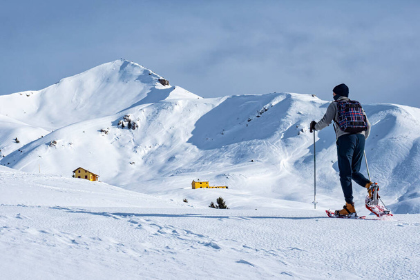Snowshoeing scene in the italian alps - Photo, Image