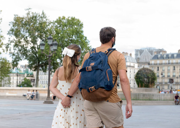 Mies ja nainen käyttävät naamioita Pariisin kaduilla. Coronavirus 2019. Pariisiin. Ranskaan. 18. elokuuta 2020. - Valokuva, kuva