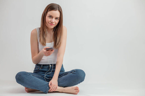 fair-haired cool girl holding mobile phone - Photo, image