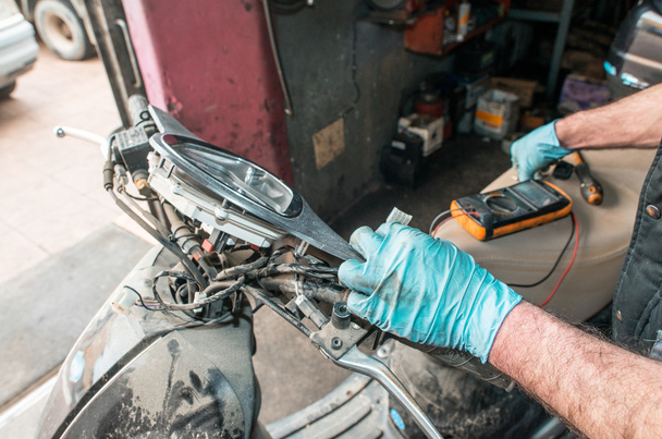 Coachbuilder repairing a motorbike - Photo, Image