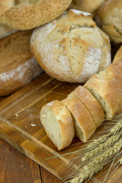 Fresh bread on wooden table - Фото, зображення