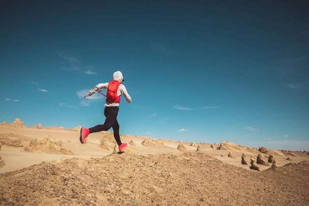 Woman trail runner cross country running  on sand desert dunes - Photo, Image