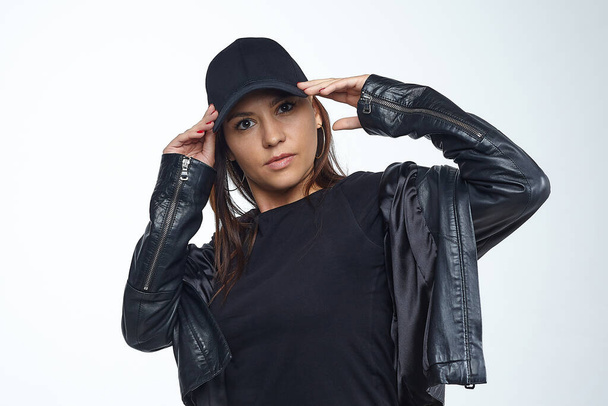 girl in a black jacket and cap in the Studio. - Photo, Image