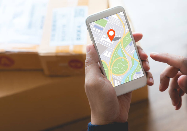 Liefer- und Online-Shopping-Konzepte mit Jugendlichen auf digitaler Landkarte mit Smartphone auf Produktverpackung box.E-Commerce-Markt.Transportlogistik.Einzelhandel. - Foto, Bild
