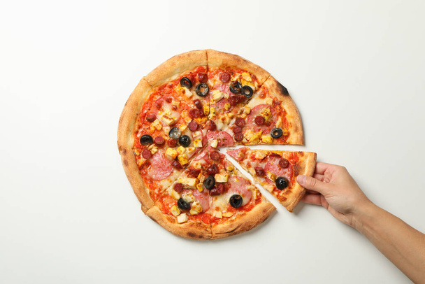 Female hand holds tasty pizza on white background - Photo, Image