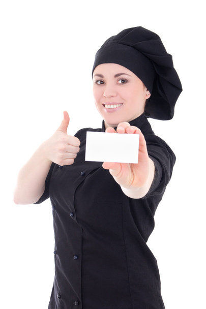 Young baker woman in black uniform showing visiting card isolate - Photo, Image