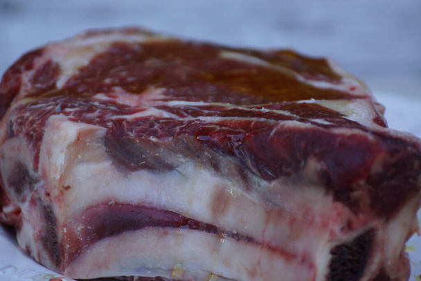 A closeup shot of raw pork for steak in a plate - Valokuva, kuva